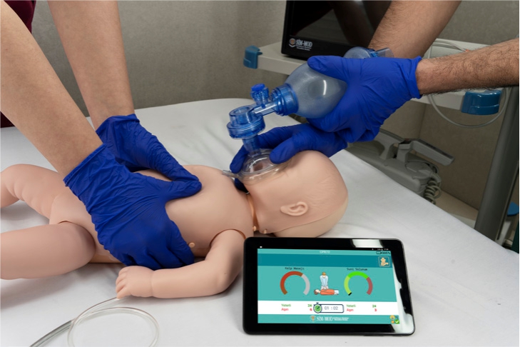 2 Infant BLS manikin showing real-time CPR performance reporting screen on tablet