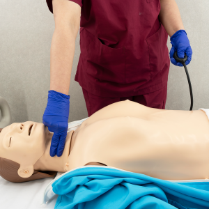 CPR manikin controller showing feedback lights for compression depth and ventilation